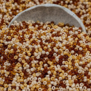 11/0 seed bead mix in caramel tones including brown, cream, amber, and warm neutral hues