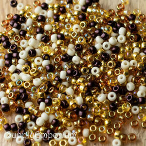 8/0 seed bead mix in neutral tones of gold, cream, brown, bronze, and warm earthy hues with a mix of matte and glossy finishes