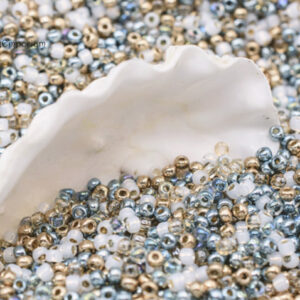 8/0 seed bead mix in soft coastal tones including ivory, champagne, pale blue, and sandy neutrals