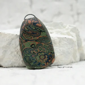 polymer clay mokume gane pendant with layered colors and embedded black iron bail