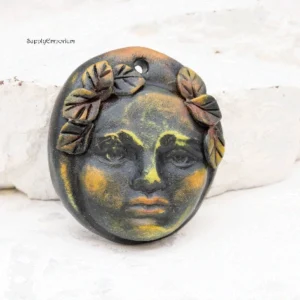 polymer clay face pendant with 3d leaves and top hole