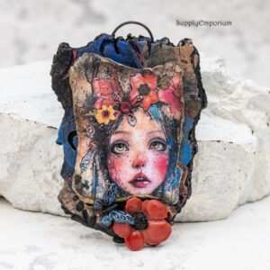 handmade polymer clay face pendant with 3D flower and butterfly embellishments