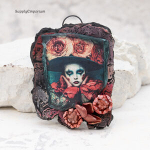 handmade polymer clay face pendant with 3D flower embellishments