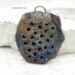 blue and orange reversible polymer clay ocean pendant with embedded black iron loop bail